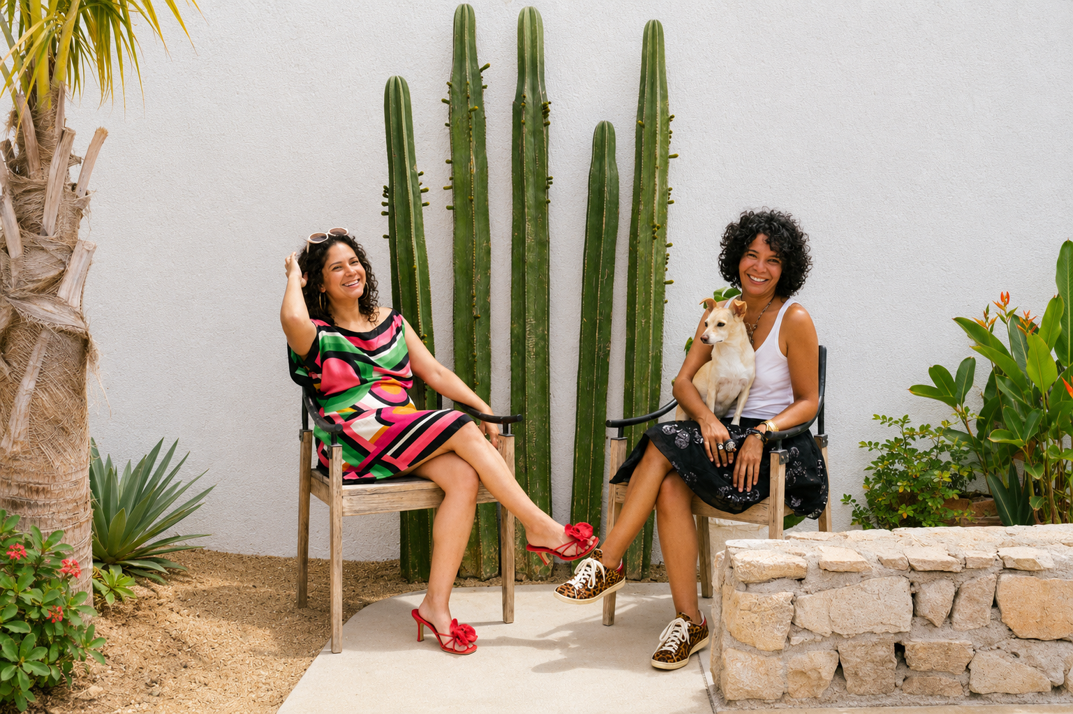 Jackie and Gladys, seated by the cactus with a dog